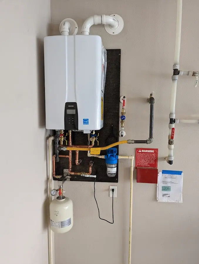 Professional plumber installing copper piping in a Combee Settlement home